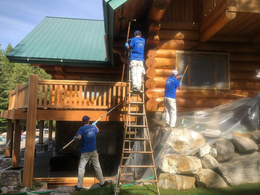 mm wood restoration applying stain to this log home