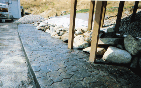 Random rock stamped concrete sealed with Lovitt's Pur-Gloss clear protector.